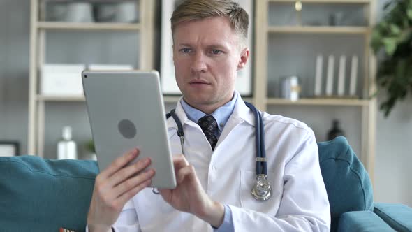 Doctor Using Tablet for Internet Browsing