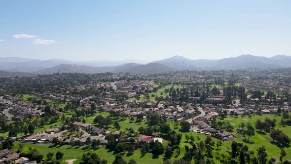 Aerial View of Residential Neighborhood Surrounded By Golf and Valley During Sunny Day in Rancho
