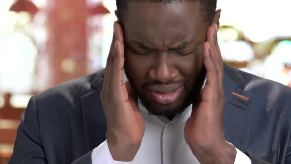 Close Up Depressed Businessman Suffering From Headache.