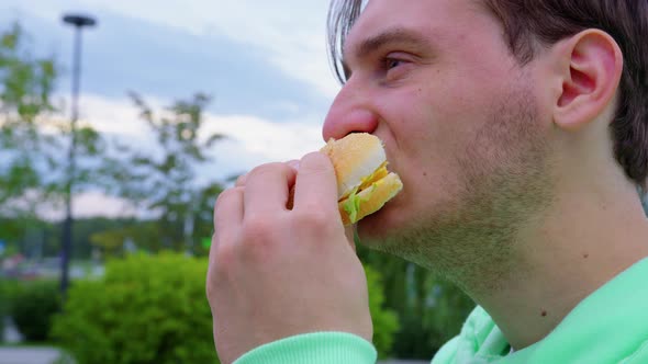 Stubble Guy Bites Off Chews Sandwich in the City Park