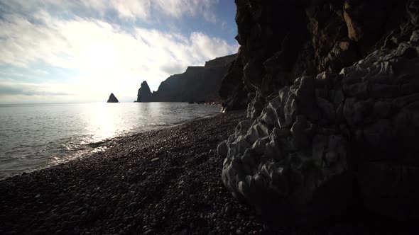 View From the Stone Cave on the Sunset Sea and the Beach the Volcanic Rock of the Cave is Lit By the