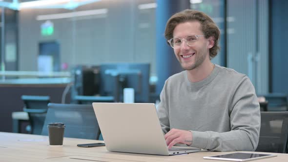 Yes Gesture By Head Shake By Young Businessman at Work