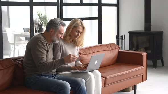 Senior Couple Screaming with Delight After Making Long Awaited Purchase