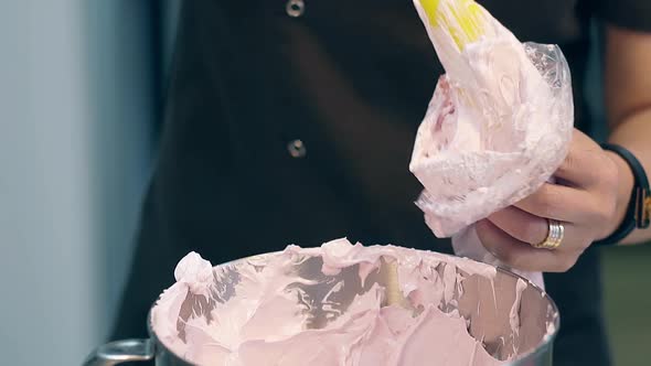 Confectioner Puts Cream Into Pastry Bag to Decorate Cake