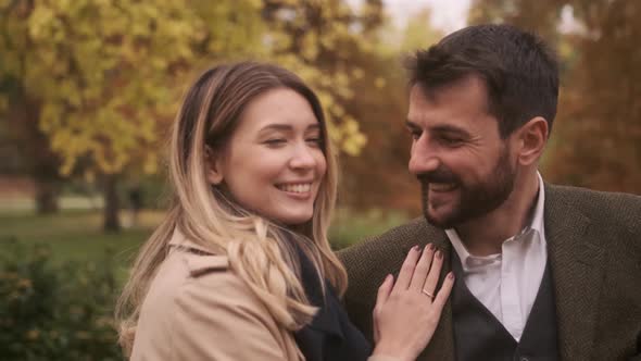 Handsome young couple walking in the autumn park