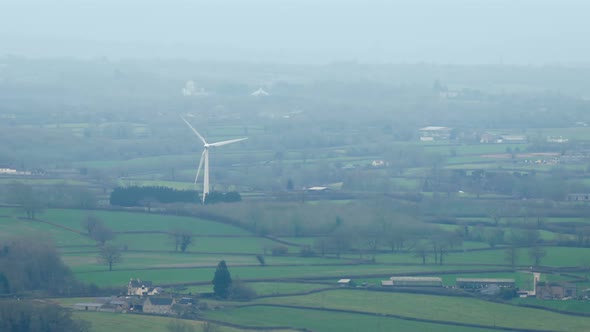 Windmill In Misty Rural Landscape