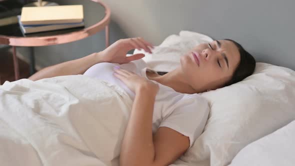 Young Latin Woman Waking Up From Sleep in Bed