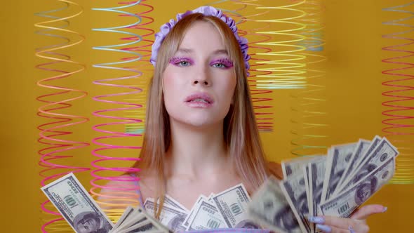 Attractive Girl Holds Dollar Banknotes in Hands