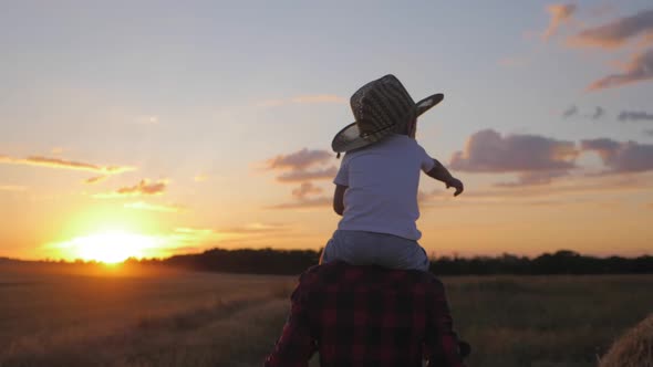 Mother and Little Son Silhouettes Playing on Meadow. Happy Family Concept.