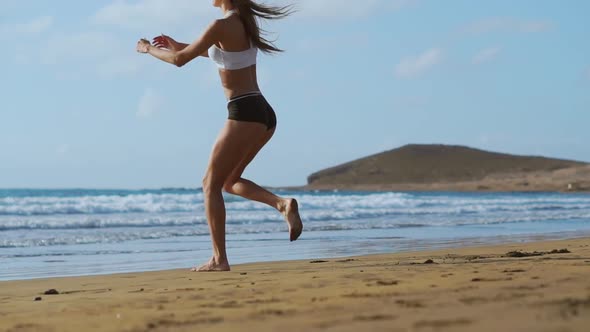 Sport Girl on a Beach Doing Lunges Exercises