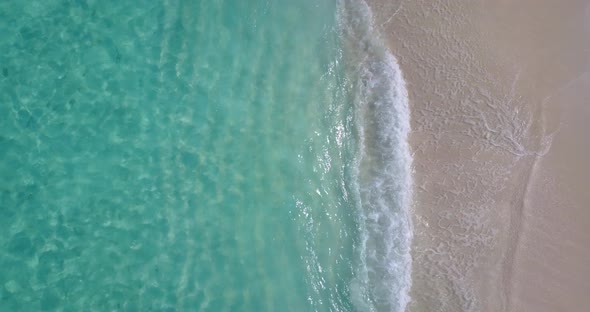 Wide fly over abstract view of a paradise sunny white sand beach and aqua blue ocean background in 4