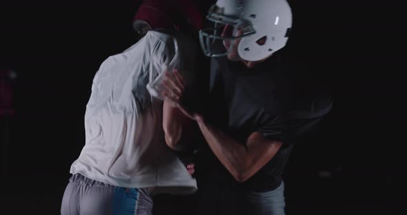 American Football Player Tackles Opponent