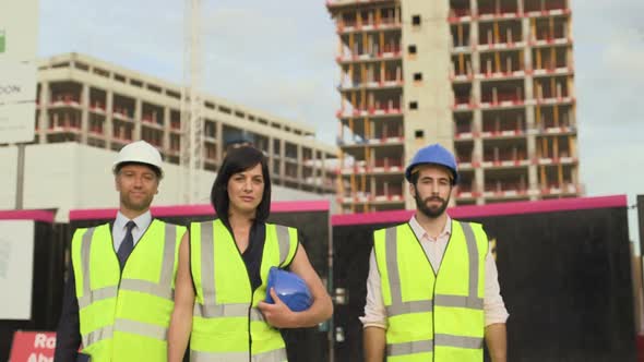 Architect confidently looking at camera at construction site