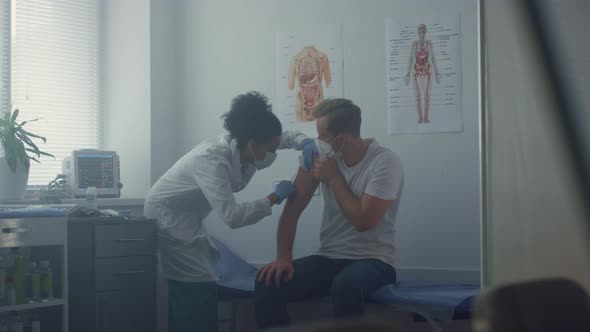 Medic Making Patient Vaccine Injection in Clinic Office