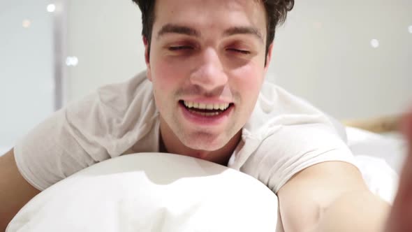 Online Video Chat By Man Lying in Bed Close Up