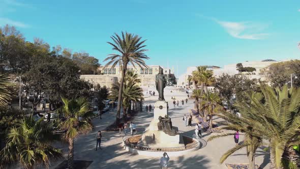 Reveal of Triton Fountain and St. John's Bastion, Valletta , Malta, Aerial forward 