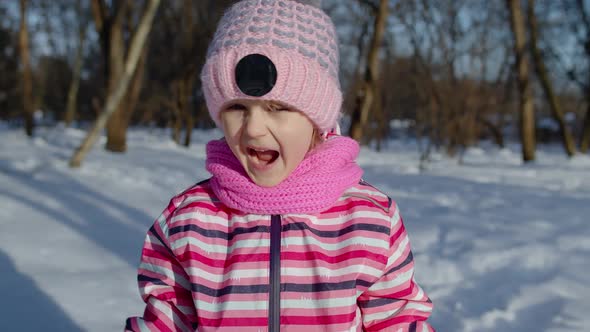 Child Girl Opening Her Mouth in Amazement Wow Delight Gesture Pleasantly Surprise in Winter Park