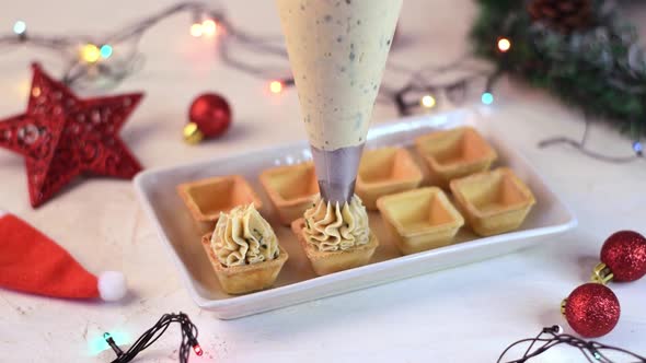 Making Christmas appetizers with savory seafood pate