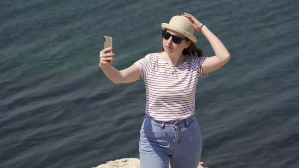 Young Woman Takes a Selfie on the Phone