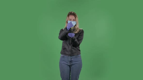 Portrait of Beautiful Young Woman in Medical Protective Face Mask Pours Medicine From Hand To Hand