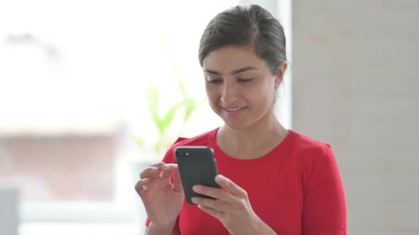 Portrait of Indian Woman Browsing Internet on Smartphone