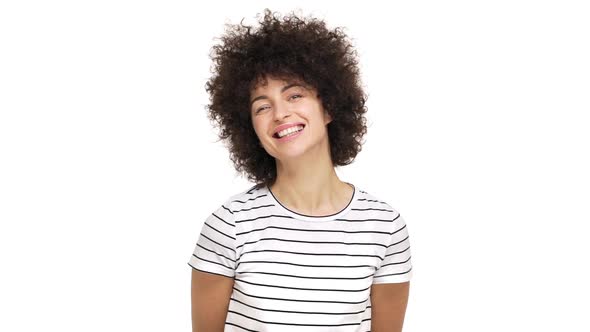 Slow Motion Portrait of Cute Young Woman Being Positive Smiling Broadly Showing Her White Teeth at