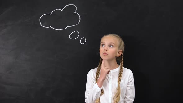 Thoughtful Schoolgirl Touching Chin and Looking to Sides Idea Sign on Blackboard