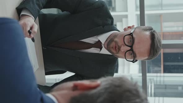 Vertical Shot of Lawyer Consulting Businessman about Legal Documents