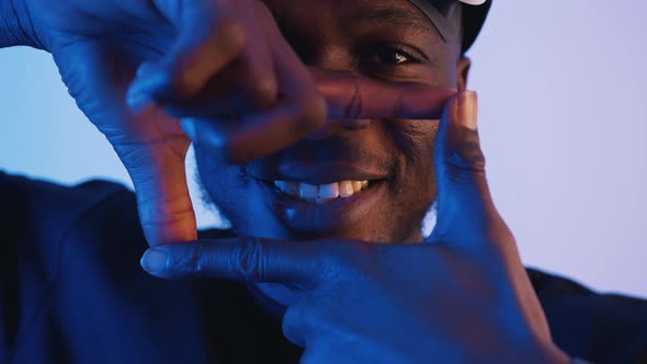 African American Man Looking at the Camera Making a Square with His Fingers