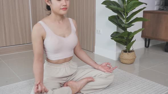 A mixed-race Chinese woman sits on the floor in the living room