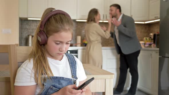 Family Scandal. Parents Quarrel. The Child Try To Be Distracted and Not Hear.