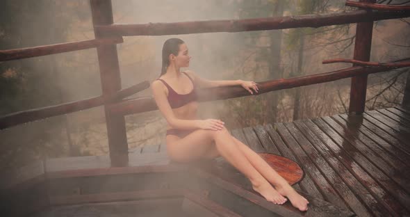 Woman in Bikini Bathing in Japanese Style Bath Outdoors