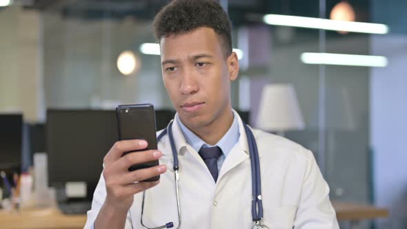 Portrait of Young Doctor Using Smartphone in Office