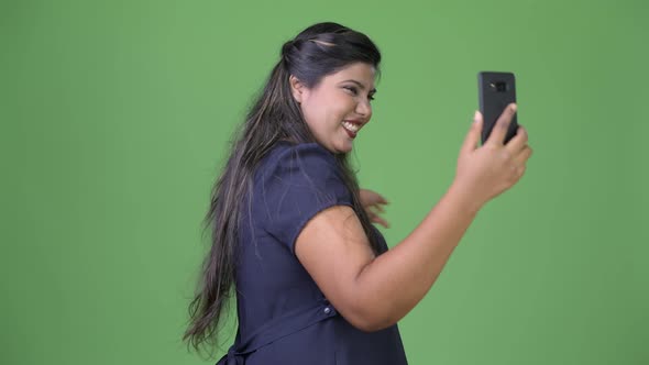 Young Overweight Beautiful Indian Businesswoman Against Green Background