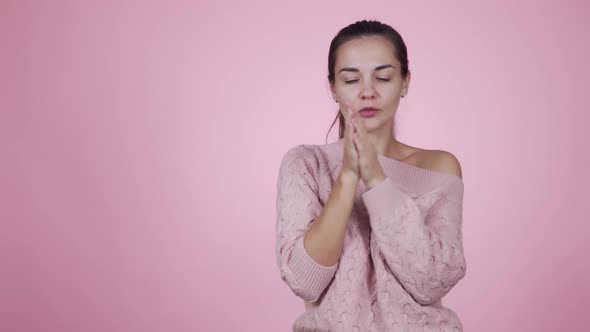 Woman Wearing in Knitted Sweater Freezes, Feels Cold Isolated on Pink Background