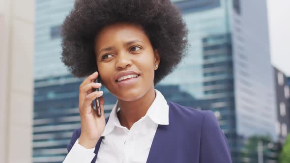 Smiling african american businesswoman talking on smartphone