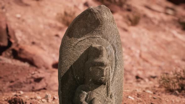 Ancient Statue on the Rocks Desert