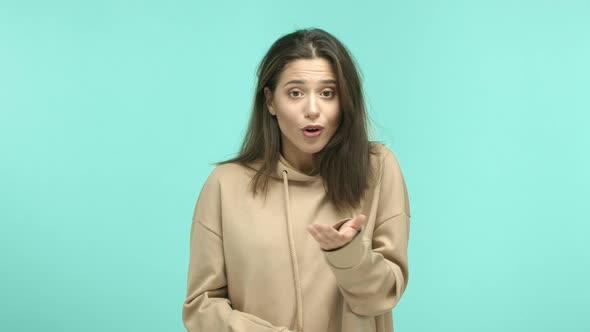 Young Woman in Beige Hoodie Telling No Shaking Head in Refusal Showing Cross Gesture to Express