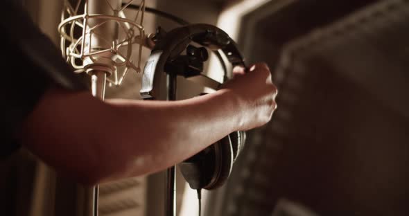 Cropped Singer Taking Headphones in Studio