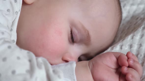 Peaceful Adorable Baby Sleeping on His Bed in a Room at Home