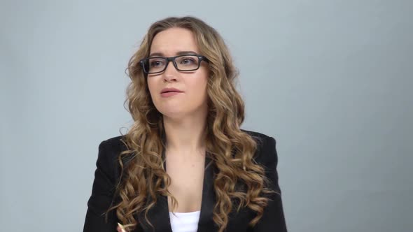 Bussines Woman Stands Worrying in Expectation at Grey Background, Slow Motion