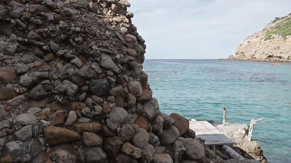 Reveal of tropical sea with Finger of God rock in Ibiza