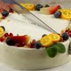 The chef cuts a cake decorated with fresh fruit. Slicing a pie close-up - VideoHive Item for Sale