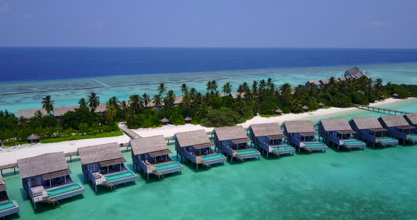 Tropical above tourism shot of a summer white paradise sand beach and aqua blue ocean background