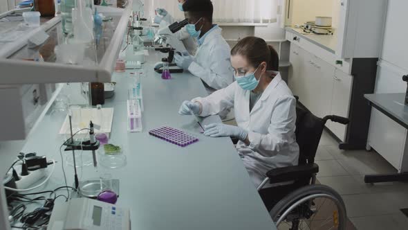 Paraplegic Female Scientist Looking at Camera in Lab