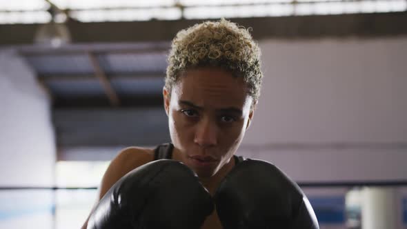 Mixed race woman with boxing gloves