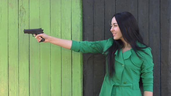 Pistol in hands of girl