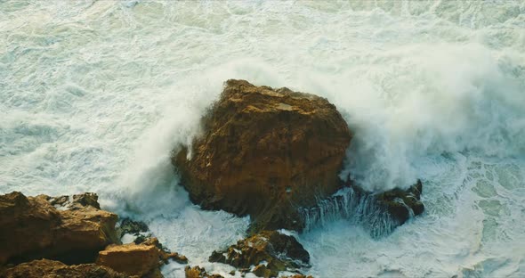 Foam Waves Rolling on Rocky Beach of Nazare Coast Portugal Europe