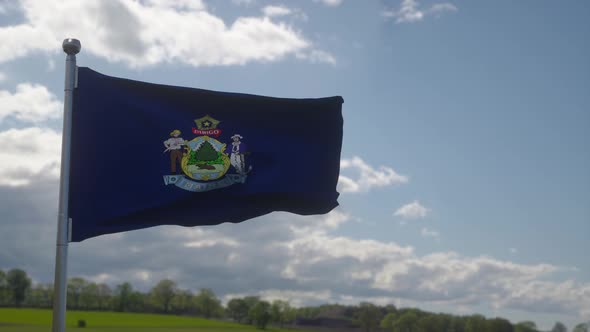 Maine Flag on a Flagpole Waving in the Wind in the Sky