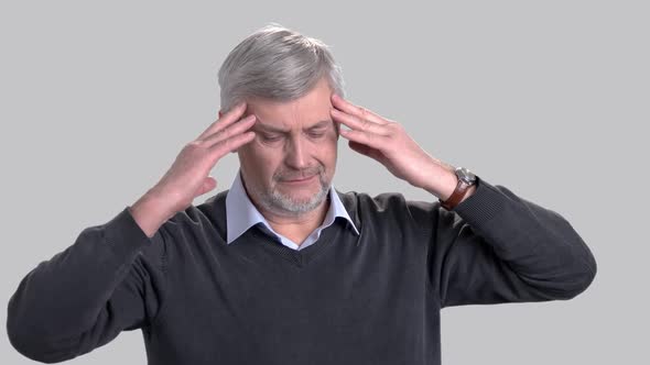 Mature Caucasian Man Suffering From Headache.